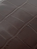 Burgundy Croc cowhide chain baguette bag close-up of the glossy burgundy croc pattern