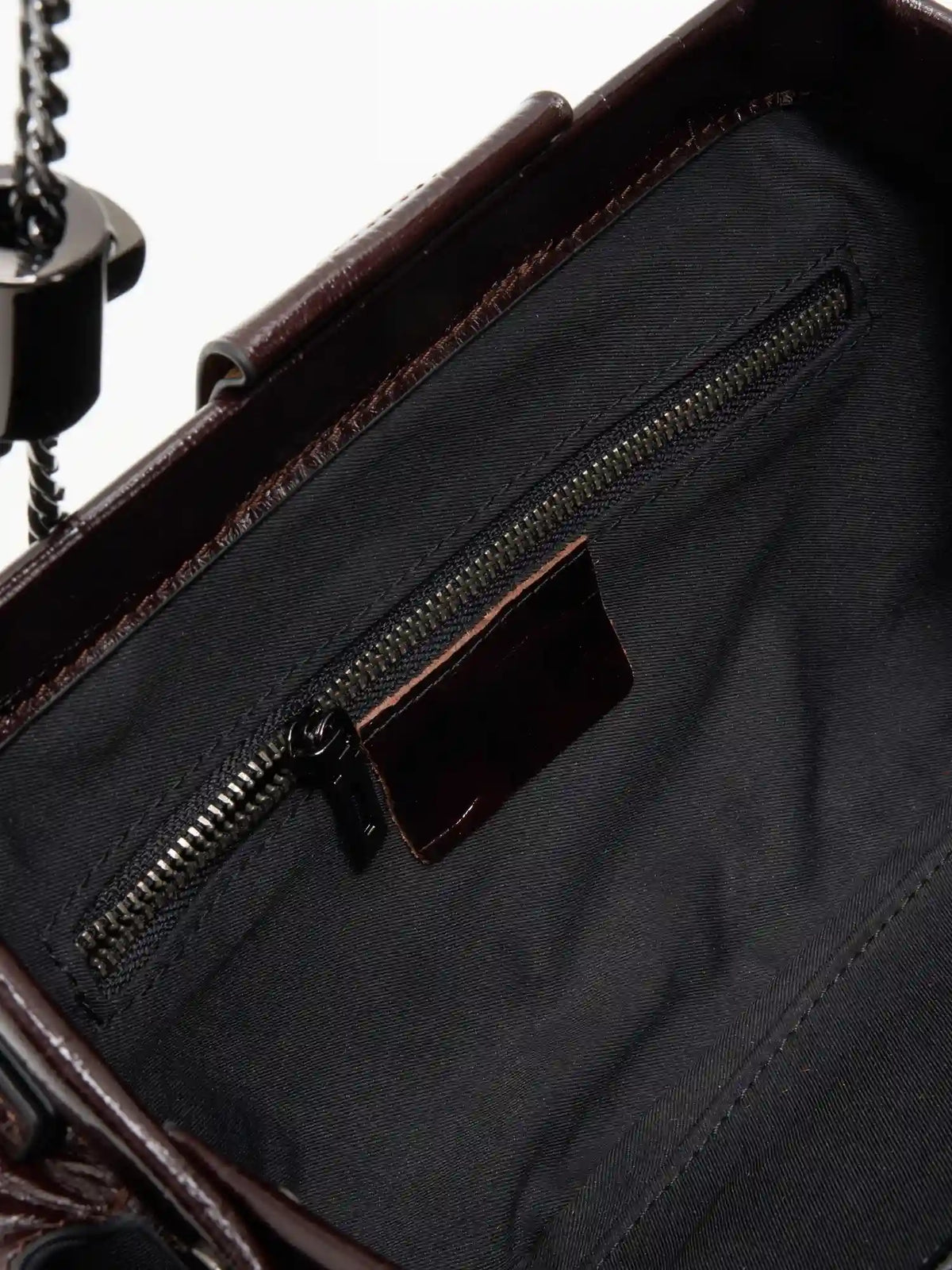 Burgundy Croc cowhide chain baguette bag close-up of the interior zip pocket and burgundy trim